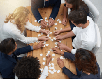 Many people doing a jigsaw